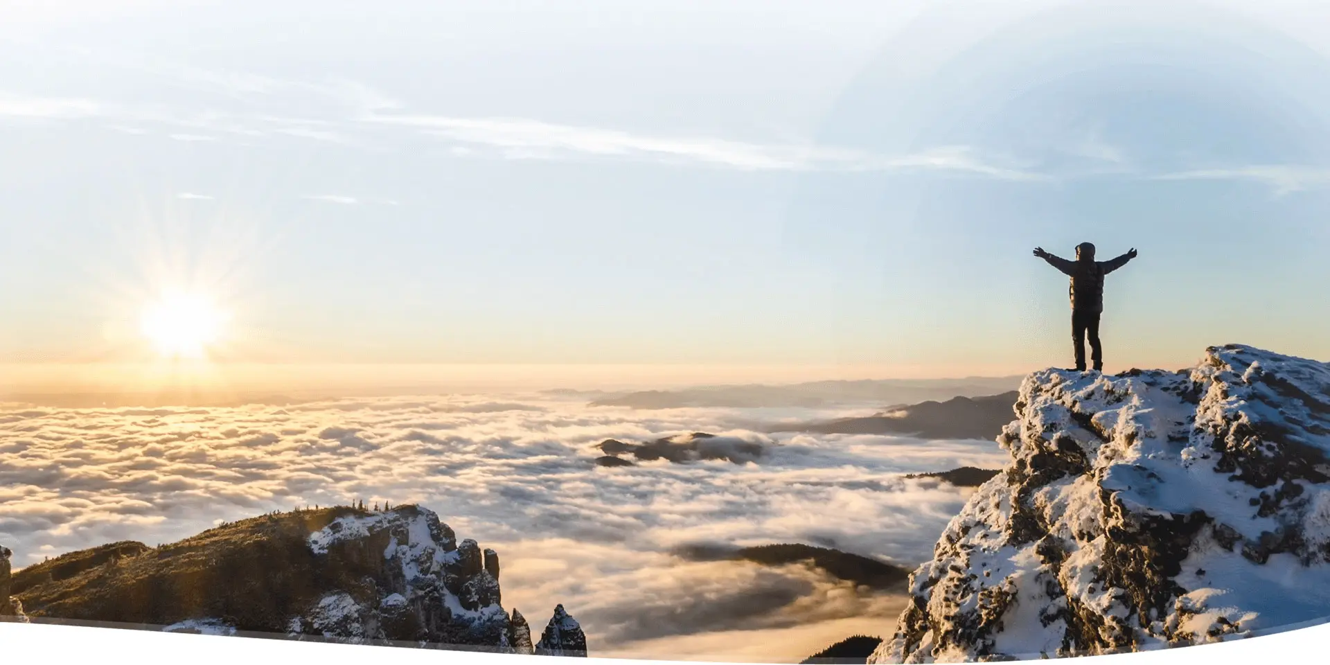 A view of the ocean from above with snow on top.